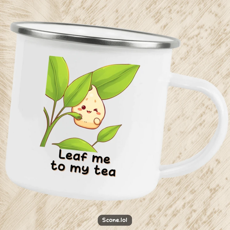 Funny Camping Mug: A scone character grins while peeking from behind a large tea leaf, bringing a humorous touch to outdoor drinks.