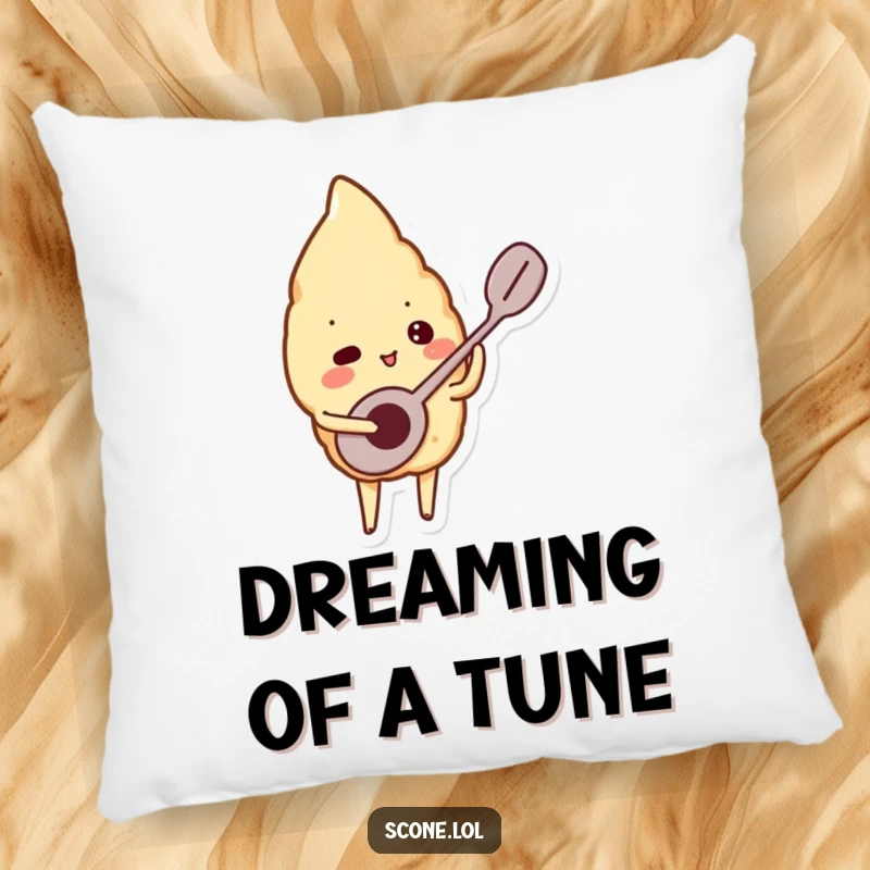 Funny pillow featuring a scone character playing a tiny spoon like a musical instrument, offering soft comfort and harmonious vibes.