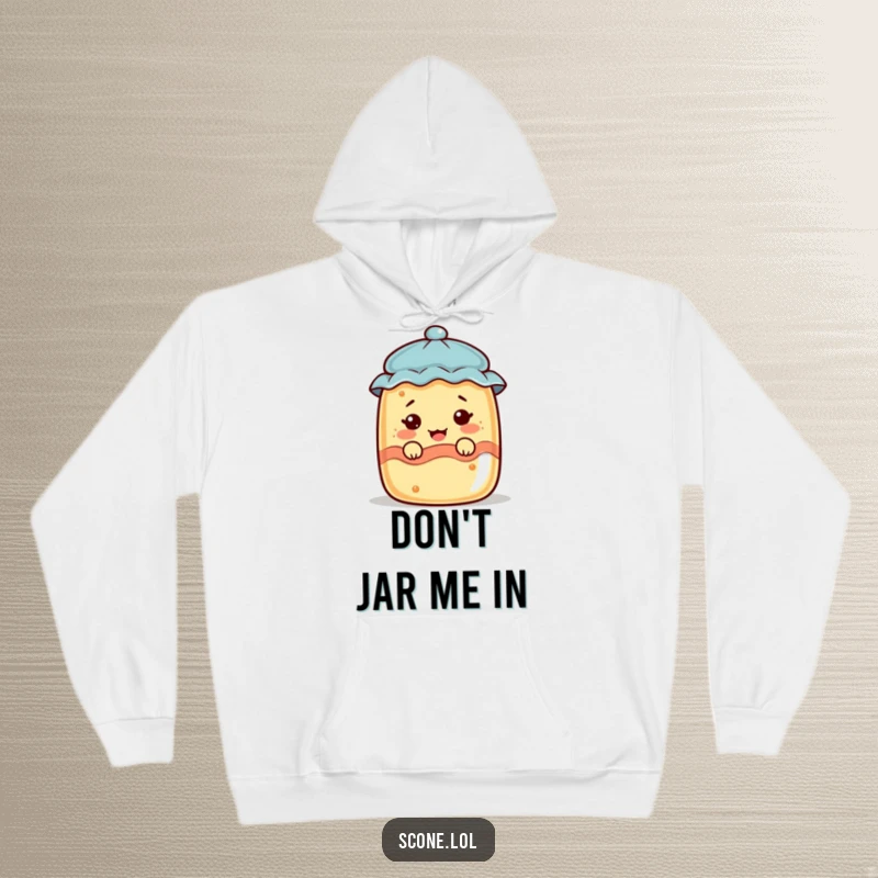 Funny scone character peeking from a jam jar, pulling a funny face, on a warm and cozy hoodie.