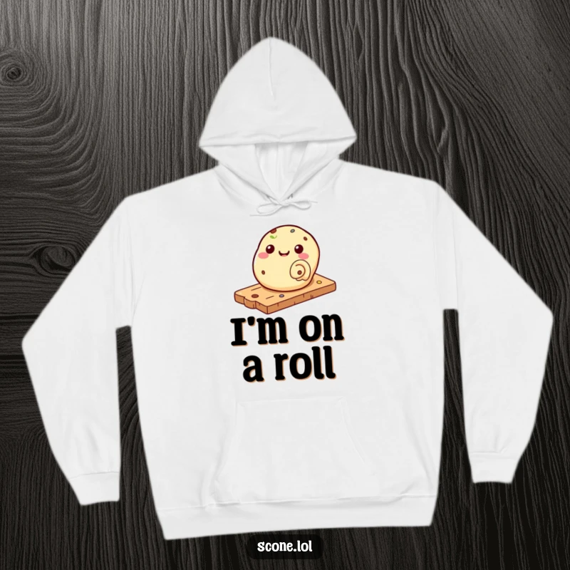 Funny hoodie depicting a scone playfully rolling down a pastry board, perfect for a cozy, humorous vibe.
