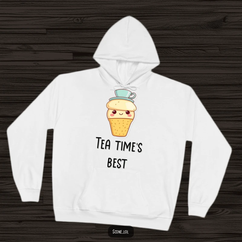 Funny scone character wearing a tiny teacup hat and a smile, designed on a cozy hoodie for ultimate comfort.