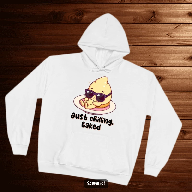 Funny scone character lounging on a plate with tiny sunglasses, a cozy hoodie that radiates baked good relaxation and playful humor.