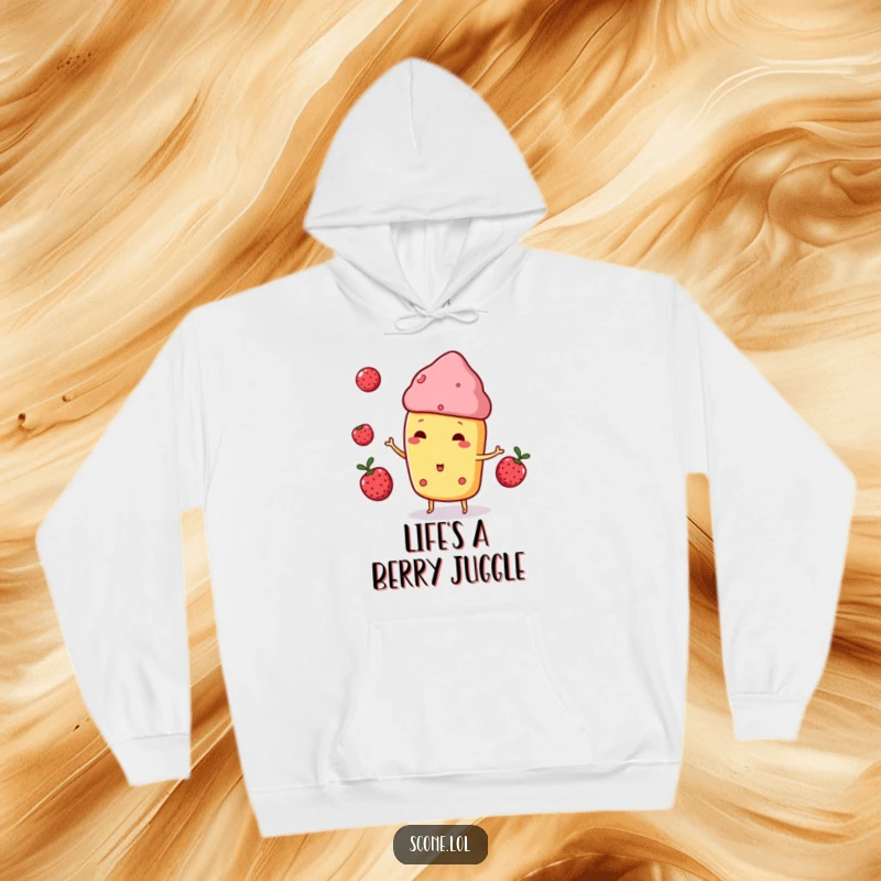 Funny Scone Character Hoodie, playfully juggling three small berries, radiating cozy, delightful energy.