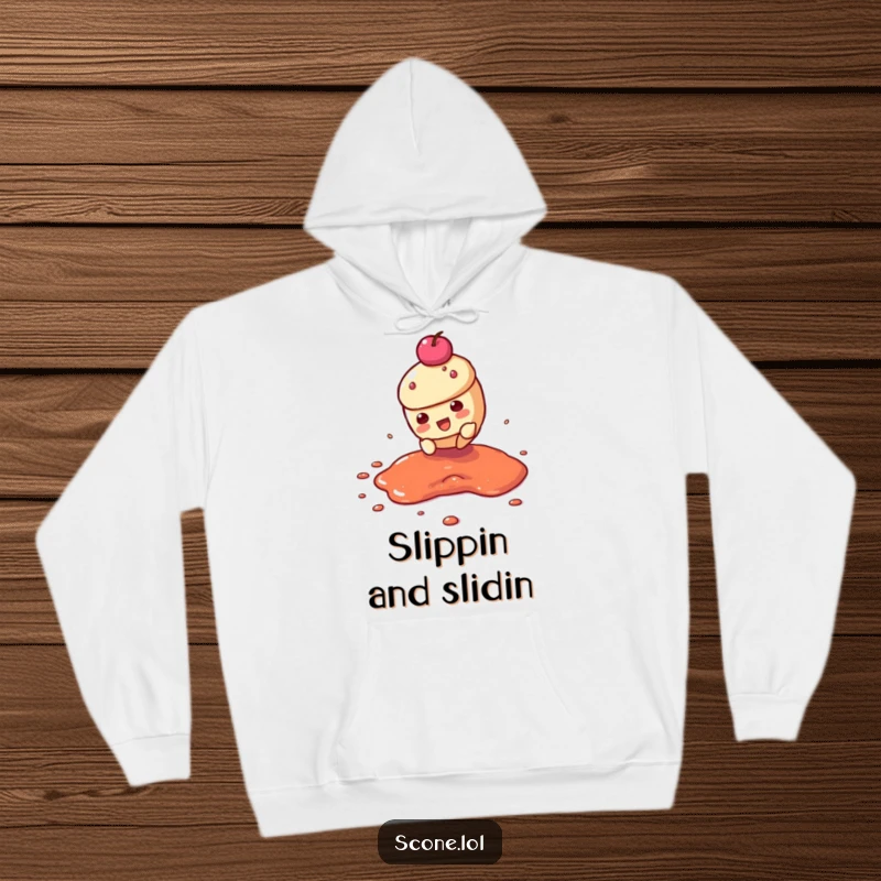 Funny hoodie showing a scone character mid-slide through a jam puddle, offering cozy comfort and humorous action.