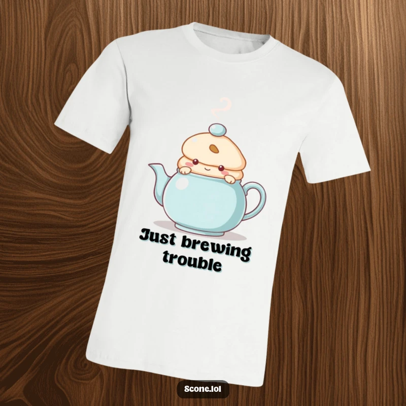 Funny T-Shirt with a scone character peeking from behind a steaming teapot, conveying a sense of playful mystery and cozy warmth.